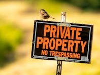 Private Property Sign with Bird Perched